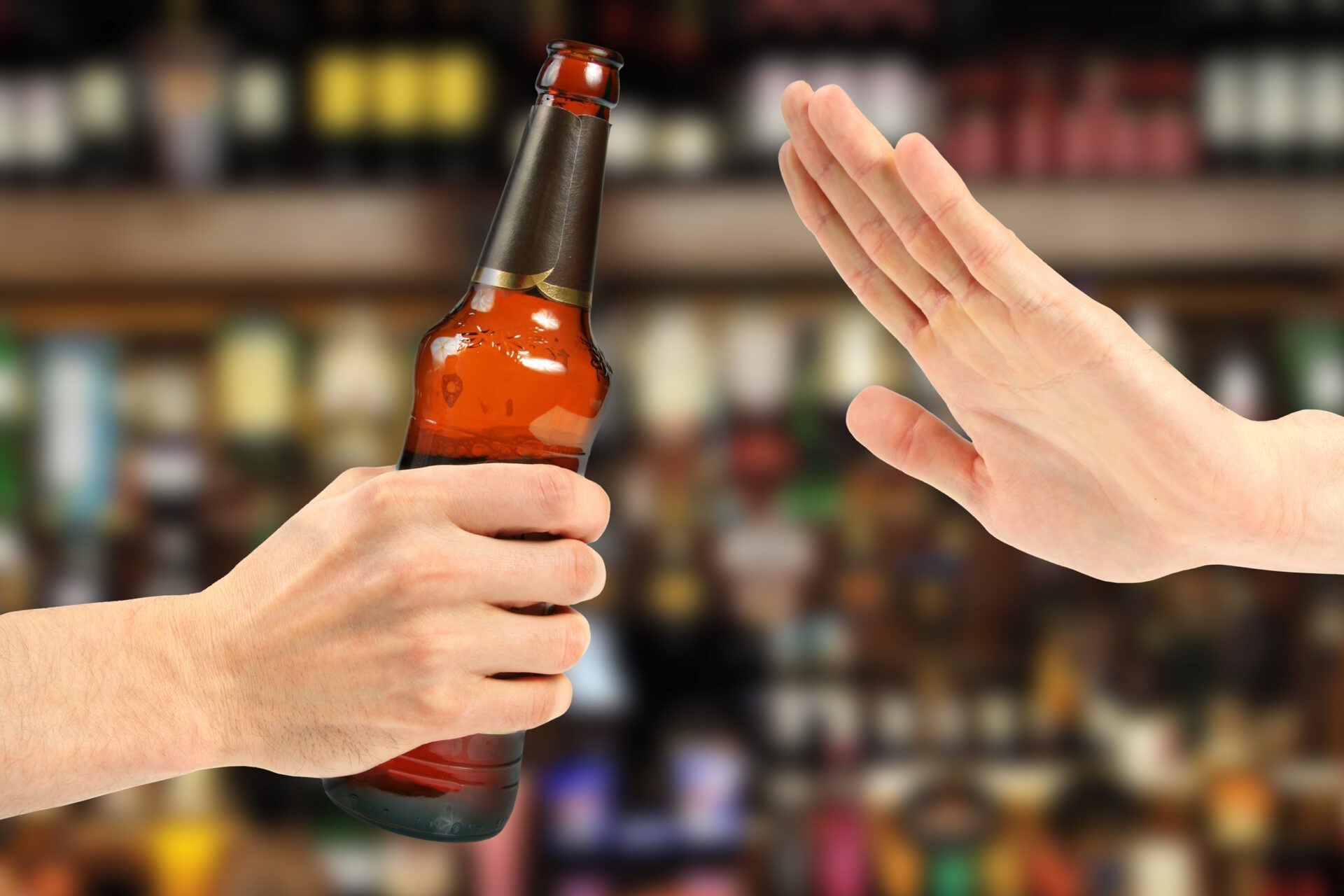 Recognizing Liver Disease Symptoms by Refusing Alcohol Hand rejecting a beer bottle, highlighting liver disease symptoms awareness