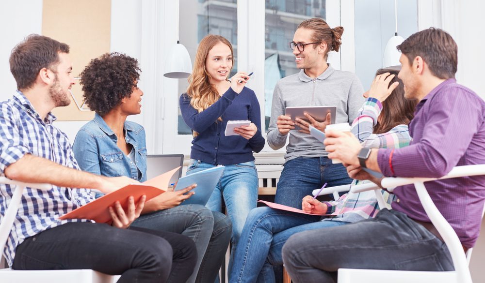 Supportive Group Therapy for Alcohol Recovery Diverse group discussing alcohol rehab strategies in a meeting